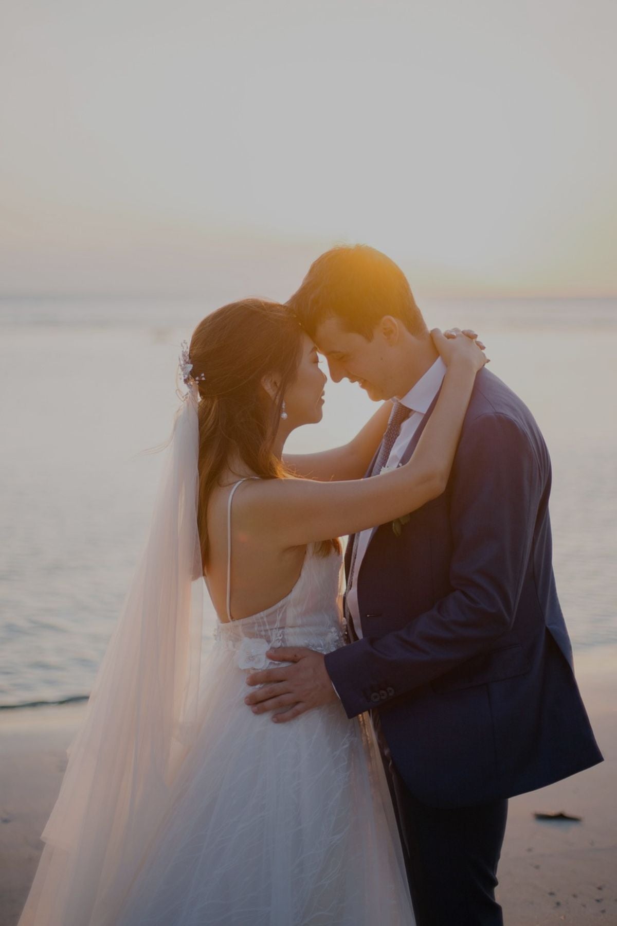 Wedding couple on beach at sunset
